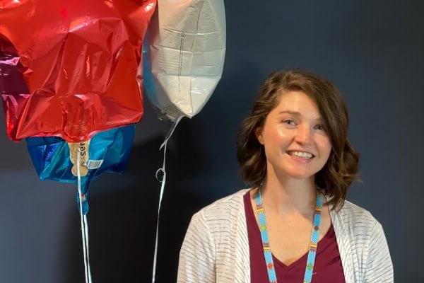Assistant Professor of Occupational Therapy Morghen Sikes, Ph.D., MS OTR/L with balloons.